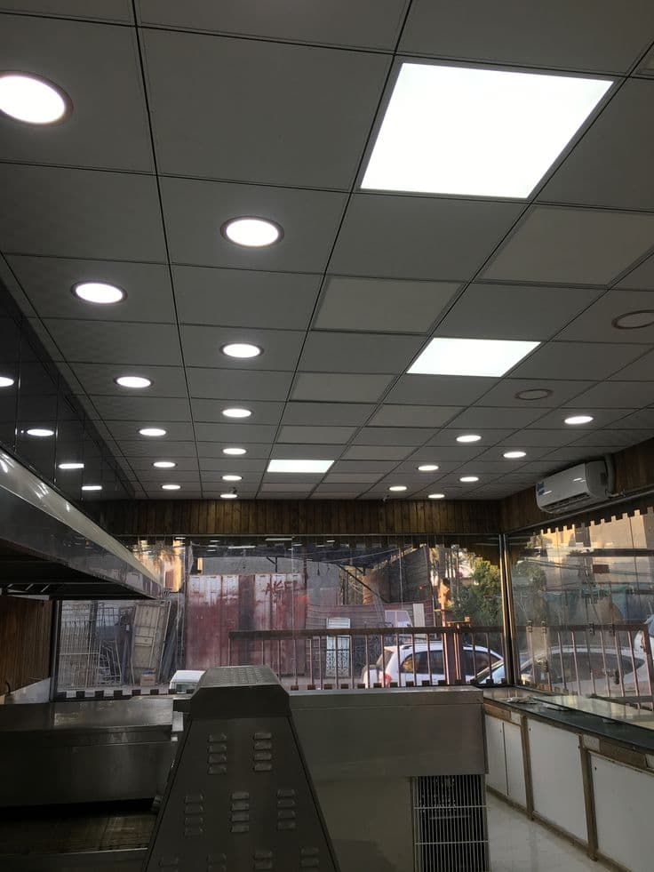 Grid false ceiling with perforated tiles and recessed lighting in a Chandigarh shop