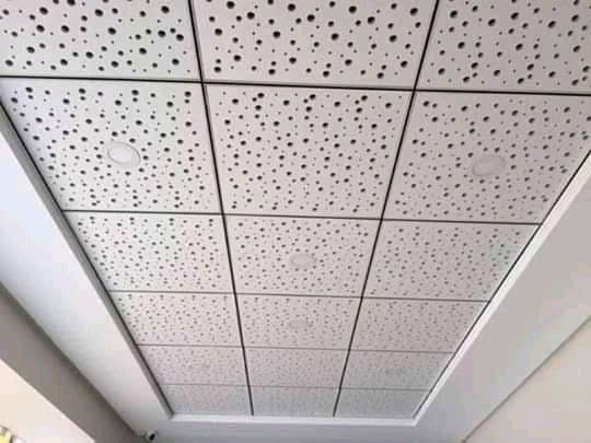 Close-up of perforated grid ceiling tiles, Chandigarh commercial interior