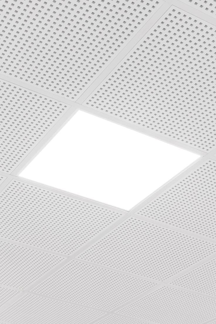 Perforated grid ceiling tile with an integrated LED panel light, Chandigarh