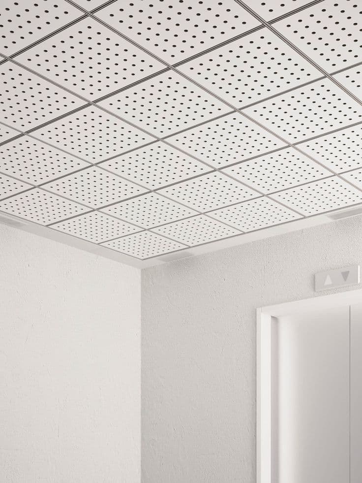Perforated grid ceiling tiles in a hallway, Manimajra Chandigarh